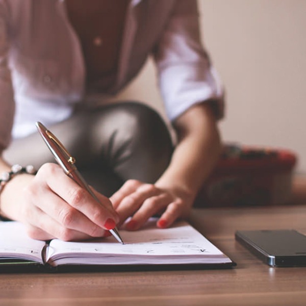 Woman writing in agenda