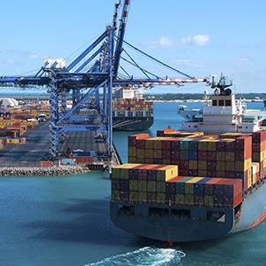 Cargo Boat with Containers entering Marine Commercial Terminal