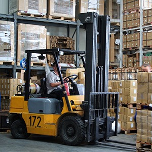 Man driving Crane in Warehouse