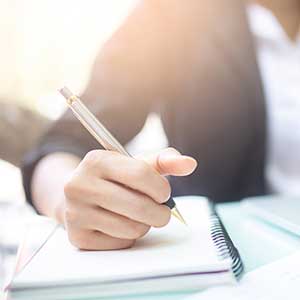 Man writing notes in journal