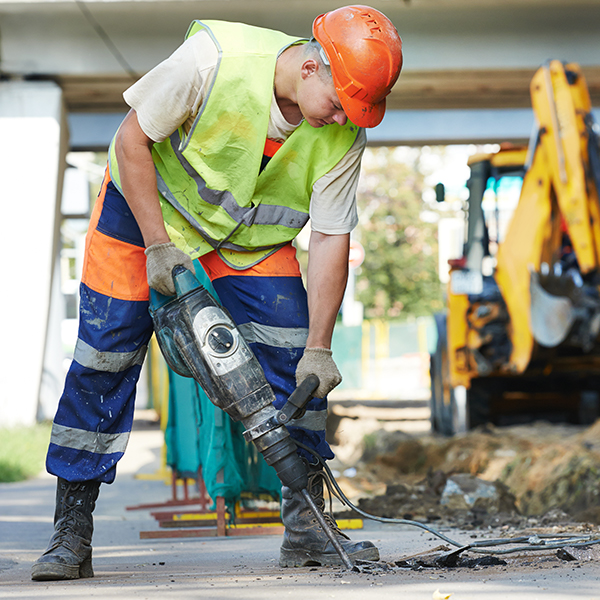 Construction man drilling street