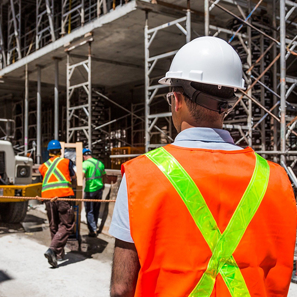 Construction workers supervising construction site