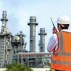 Worker supervising oil plant factory