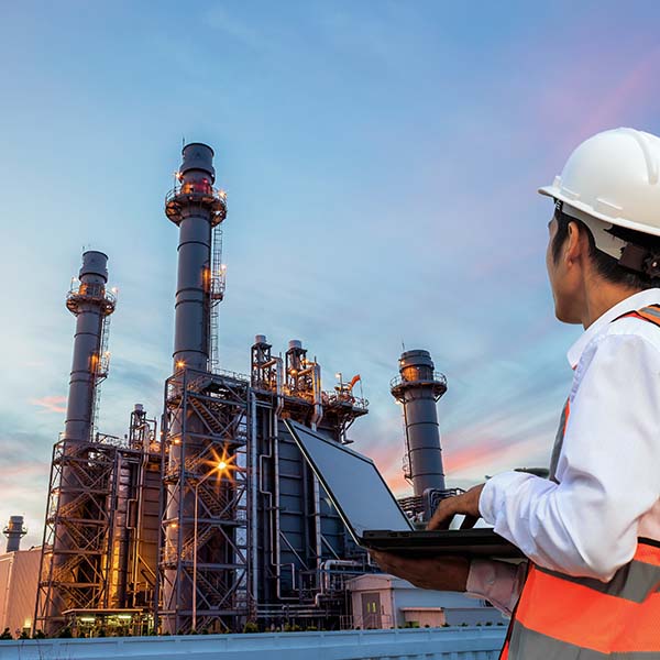 Engineer man looking over oil factory