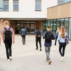 Students outside of the school walking towards the entrance