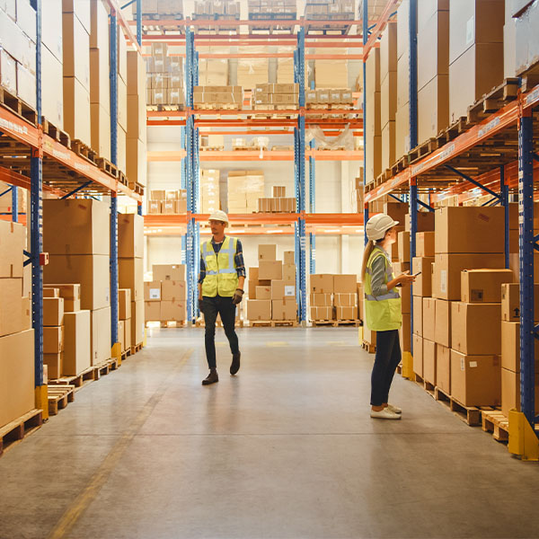 Workers going over inventory in storage warehouse