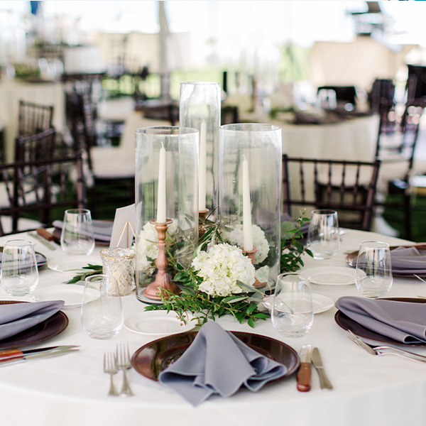 Event arrangement of tables and chairs with silverware